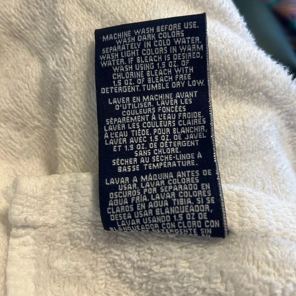2 sports towels. 1 is reversible and has a tennis player. 1 is izod brand.